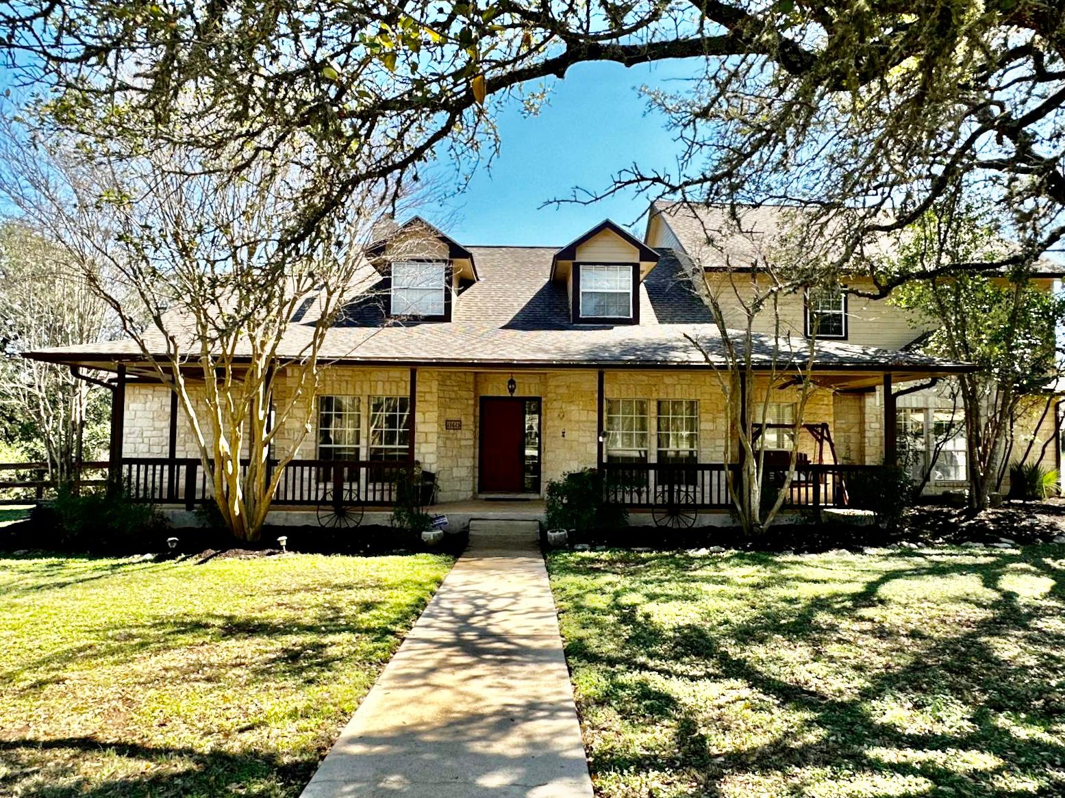 13615 Copperleaf Trail Manchaca, TX 78652 - Photo 1 of 39 View of front of home with a porch, a front yard, and stone siding