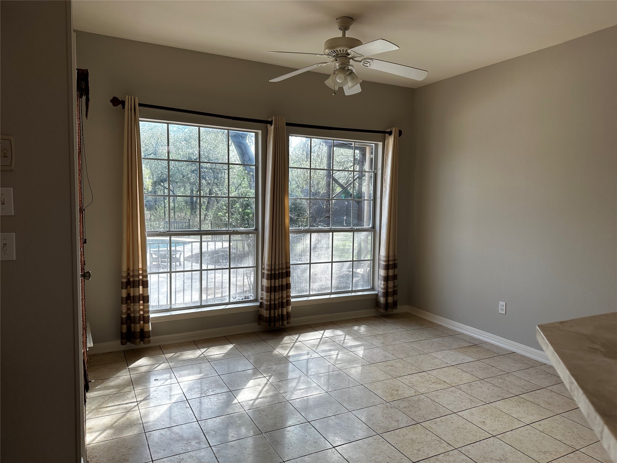 13615 Copperleaf Trail Manchaca, TX 78652 - Photo 11 of 39 Spare room featuring baseboards and a ceiling fan