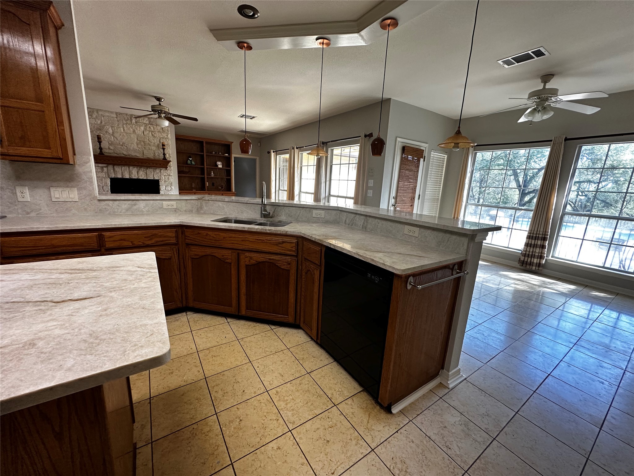 13615 Copperleaf Trail Manchaca, TX 78652 - Photo 12 of 39 Kitchen featuring ceiling fan, pendant lighting, black dishwasher, and a peninsula