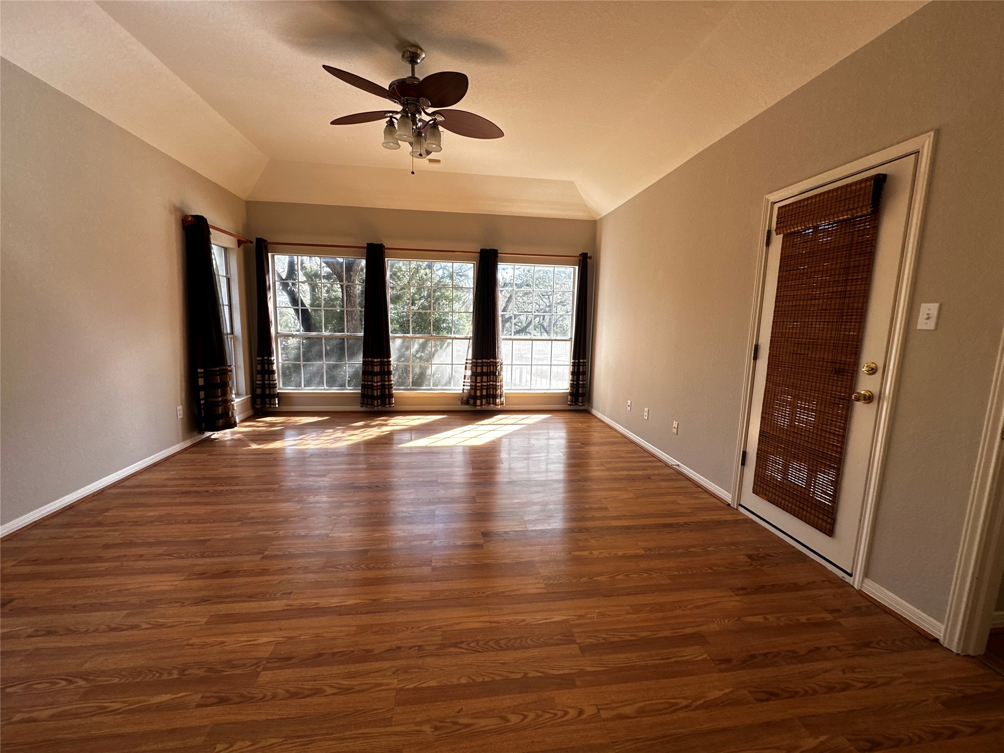 13615 Copperleaf Trail Manchaca, TX 78652 - Photo 19 of 39 Unfurnished room with ceiling fan, dark wood-style floors, and lofted ceiling