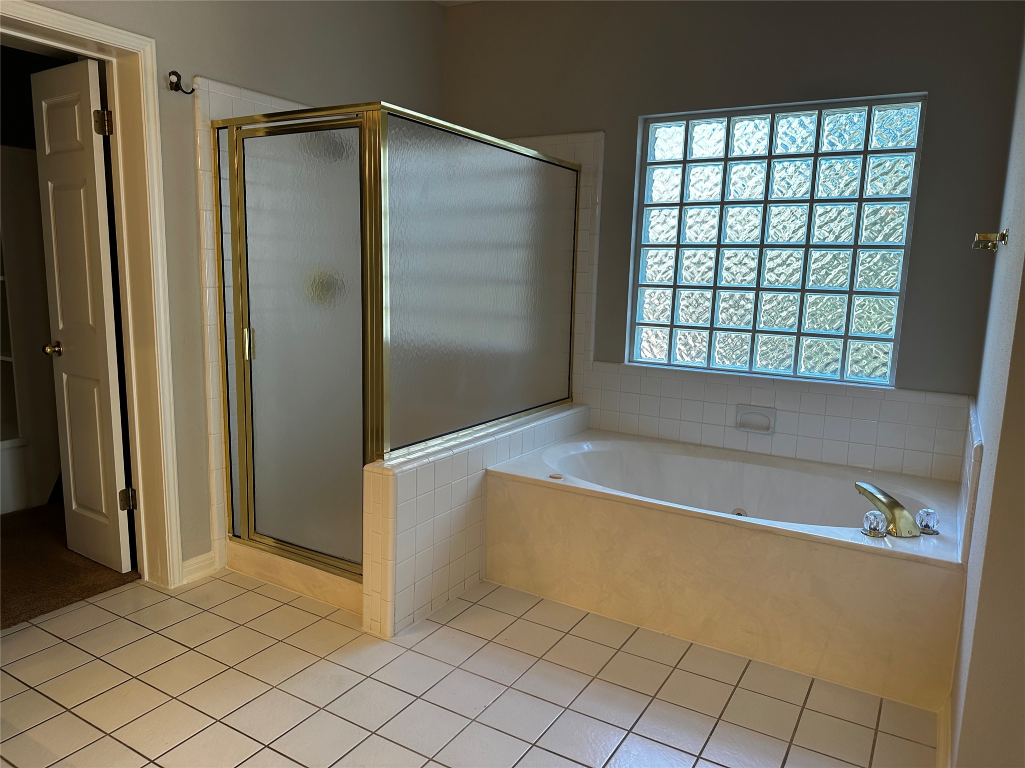 13615 Copperleaf Trail Manchaca, TX 78652 - Photo 23 of 39 Full bathroom with a bath, a shower stall, and light tile patterned floors