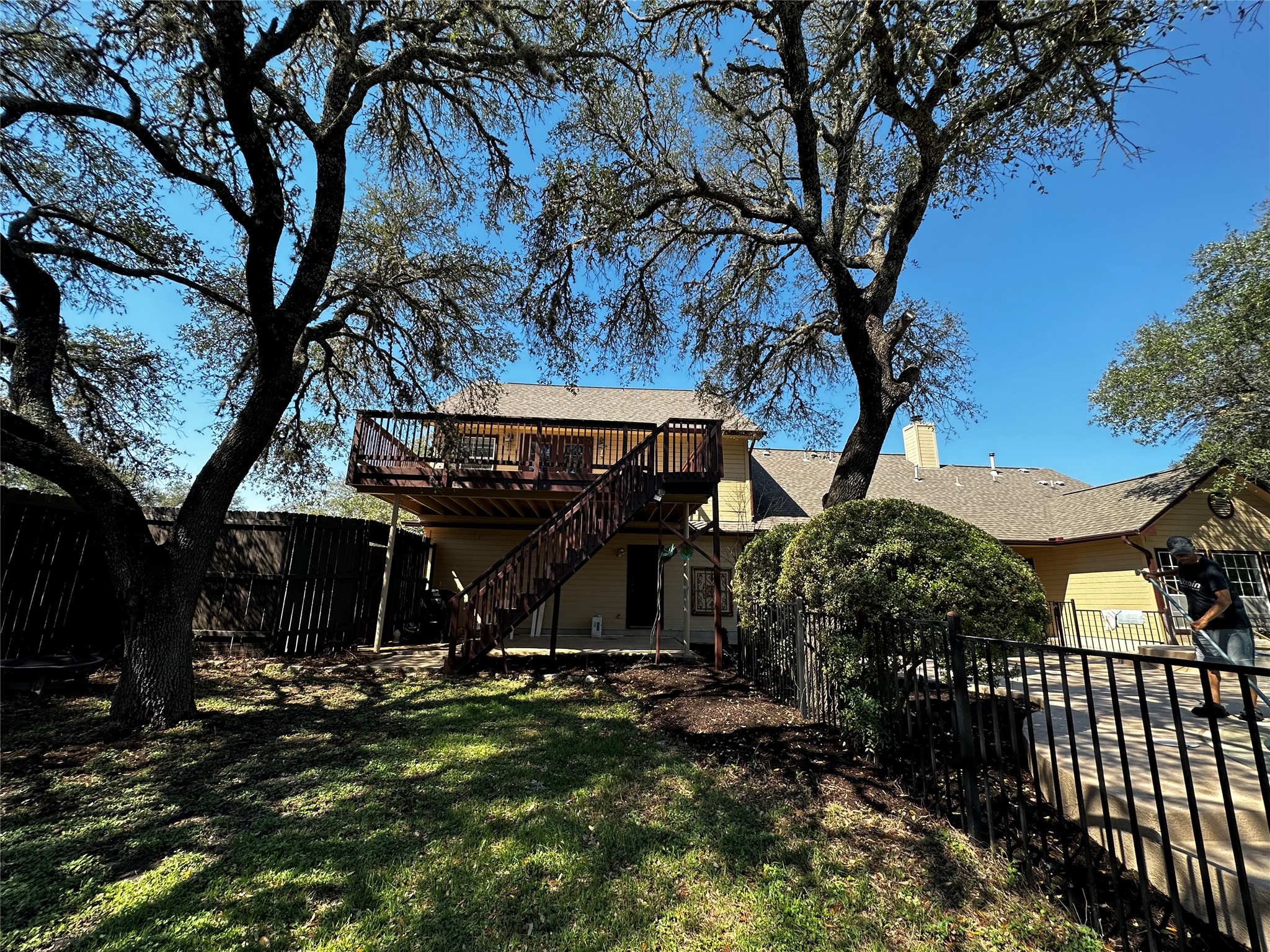 13615 Copperleaf Trail Manchaca, TX 78652 - Photo 31 of 39 Rear view of house with a fenced backyard, a deck, and a chimney