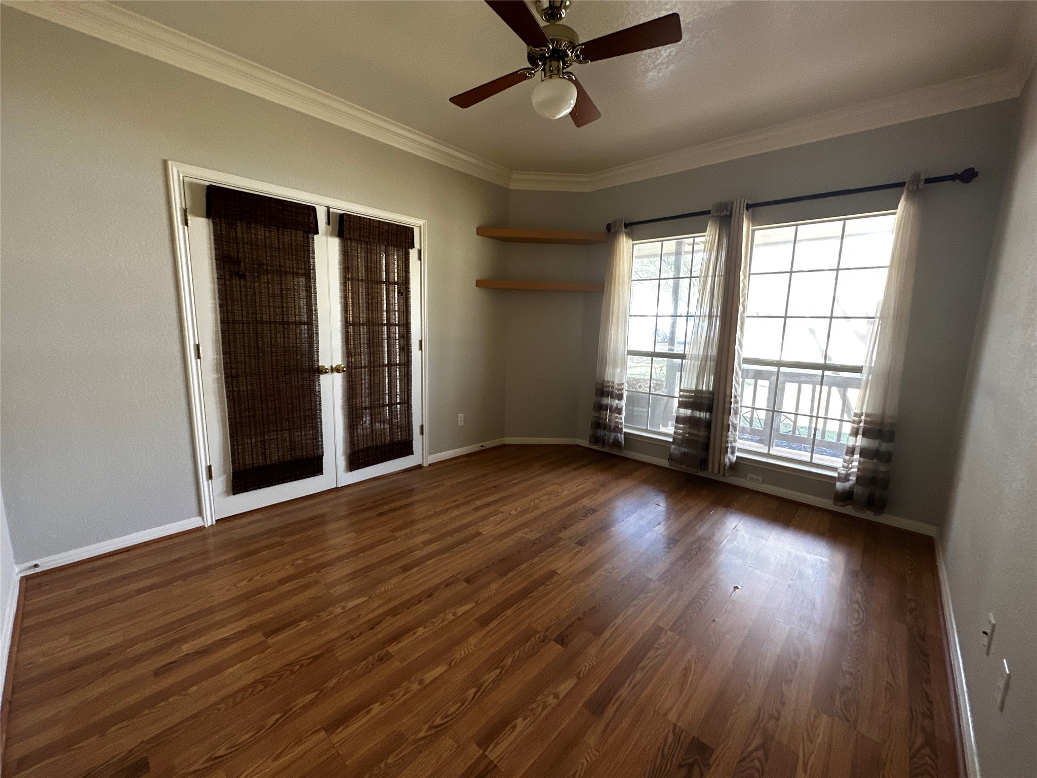 13615 Copperleaf Trail Manchaca, TX 78652 - Photo 5 of 39 Unfurnished room with crown molding, ceiling fan, and dark wood finished floors