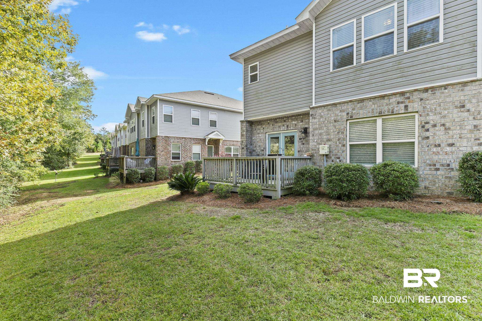 6867 Spaniel Drive, Unit B Daphne, AL 36527 - Photo 26 of 36 Exterior space featuring a yard and a wooden deck