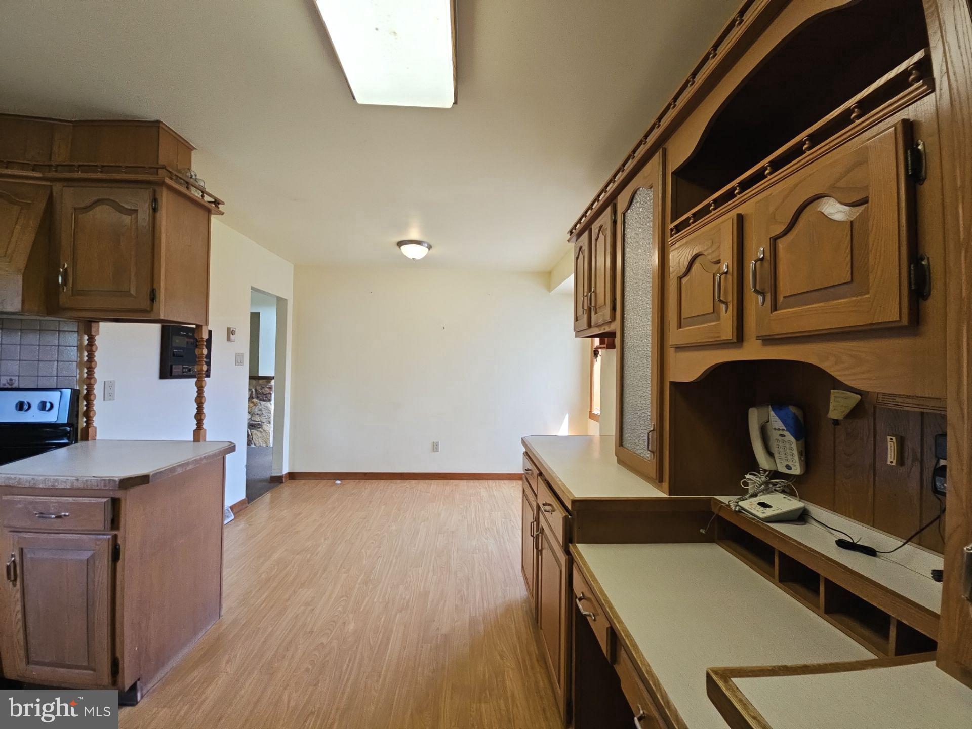 911 Gum Tree Corner Road Greenwich, NJ 08323 - Photo 27 of 47 a kitchen with a refrigerator and a stove top oven