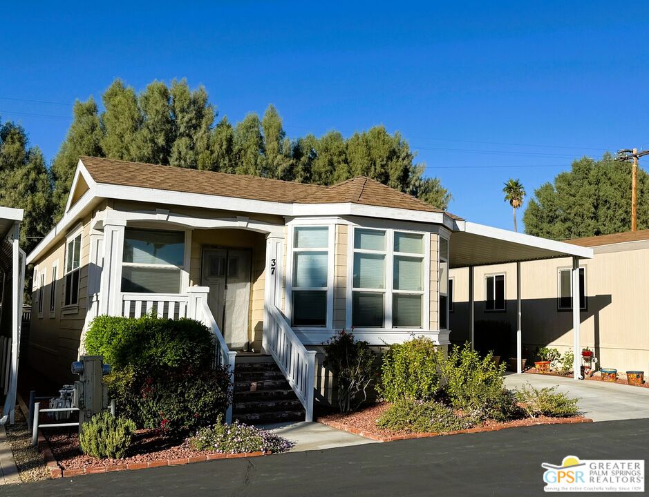 17640 Corkill Road, Unit 37 Desert Hot Springs, CA 92241 - Photo 1 of 35 a front view of a house with garden