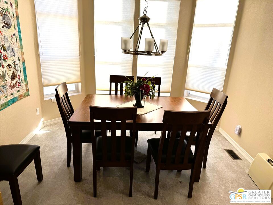 17640 Corkill Road, Unit 37 Desert Hot Springs, CA 92241 - Photo 12 of 35 a view of a dining room with furniture and window