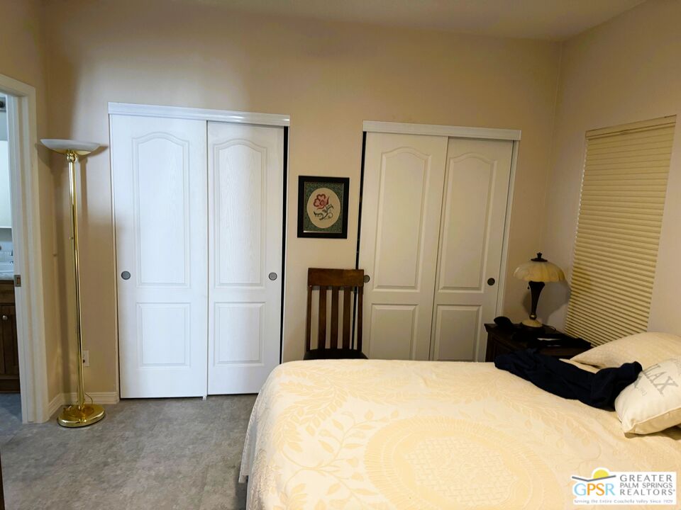 17640 Corkill Road, Unit 37 Desert Hot Springs, CA 92241 - Photo 14 of 35 a bedroom with a bed and a table