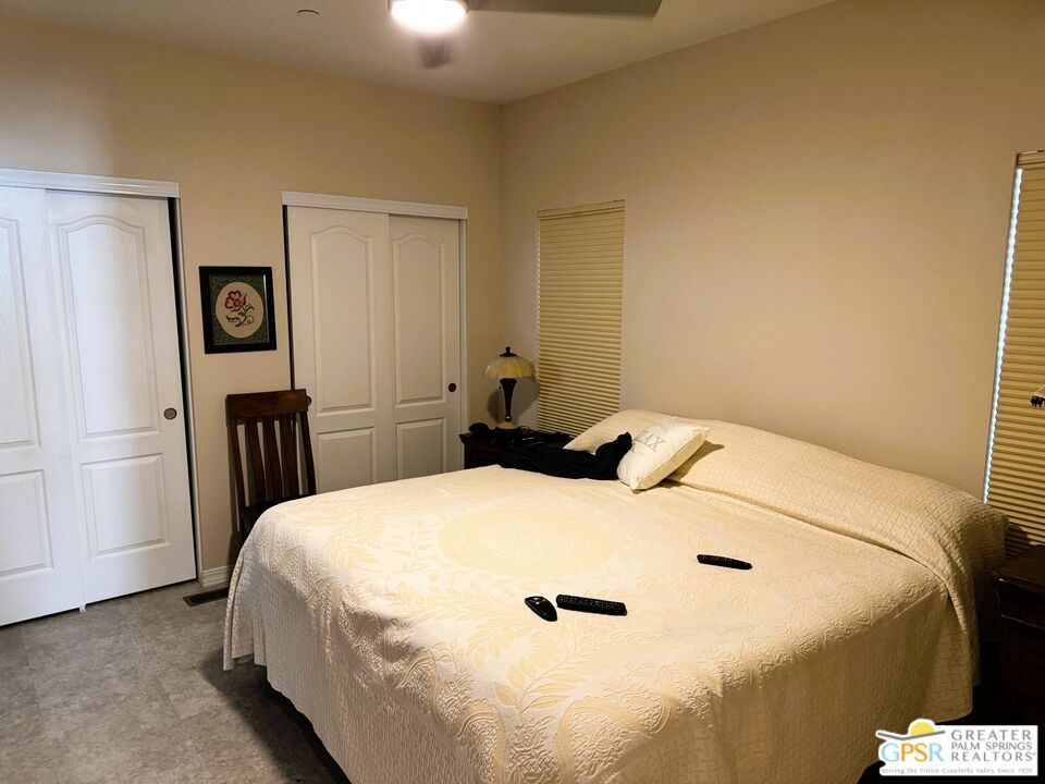 17640 Corkill Road, Unit 37 Desert Hot Springs, CA 92241 - Photo 15 of 35 a bedroom with a bed and a table