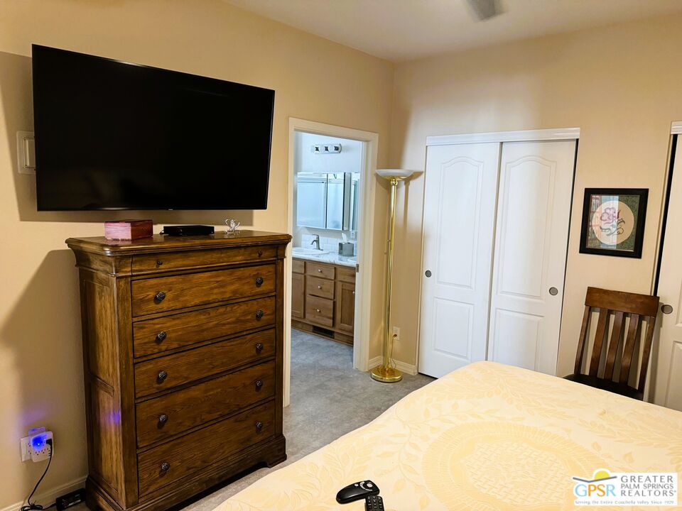17640 Corkill Road, Unit 37 Desert Hot Springs, CA 92241 - Photo 16 of 35 a bedroom with a bed and a flat screen tv