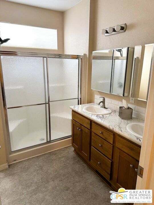 17640 Corkill Road, Unit 37 Desert Hot Springs, CA 92241 - Photo 17 of 35 a bathroom with a double vanity sink and a mirror