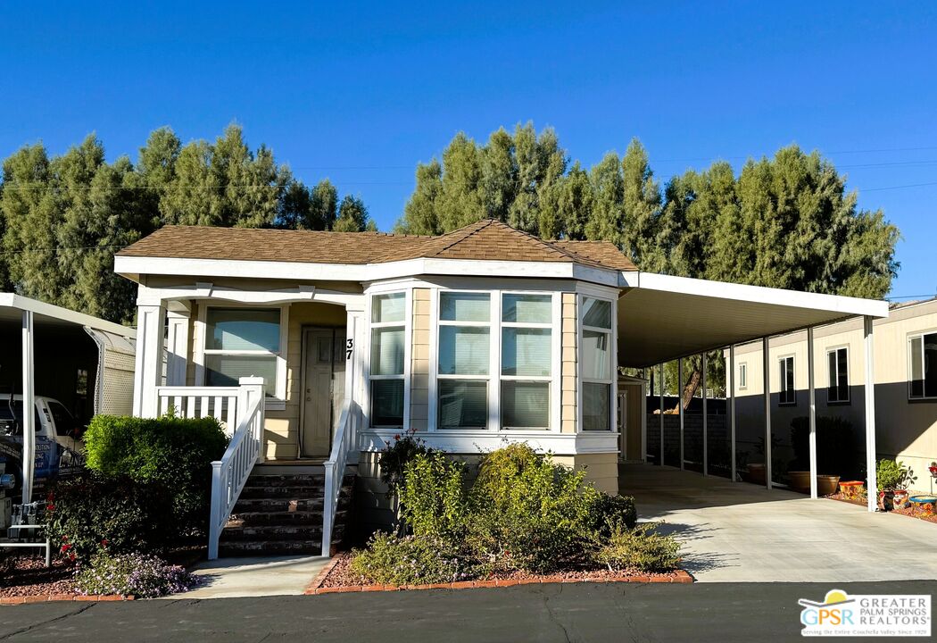 17640 Corkill Road, Unit 37 Desert Hot Springs, CA 92241 - Photo 2 of 35 a front view of a house with a yard
