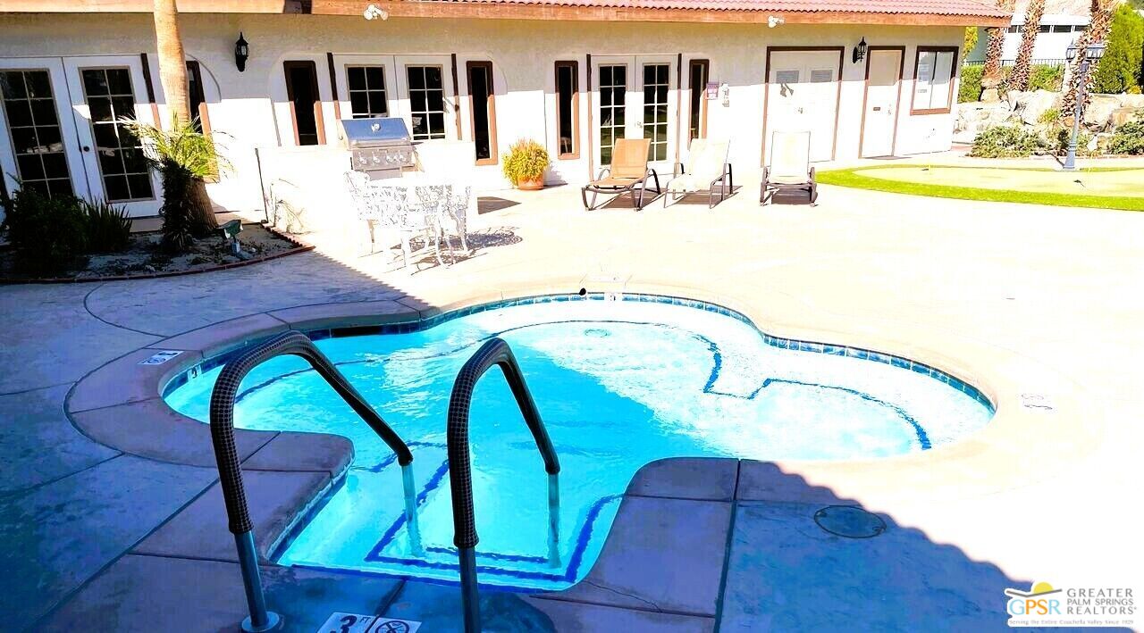 17640 Corkill Road, Unit 37 Desert Hot Springs, CA 92241 - Photo 23 of 35 a view of a swimming pool with a patio