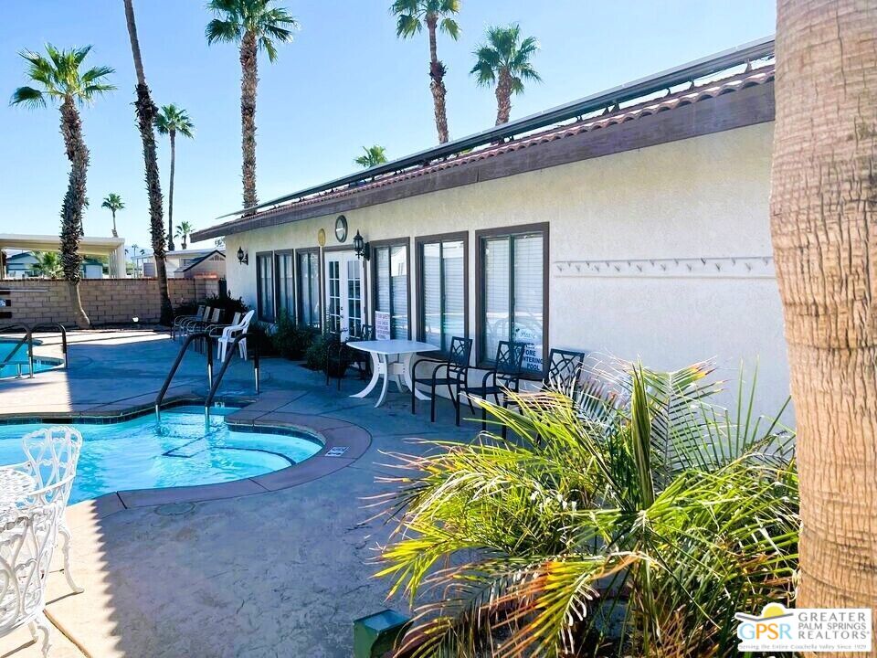 17640 Corkill Road, Unit 37 Desert Hot Springs, CA 92241 - Photo 25 of 35 a swimming pool with outdoor seating