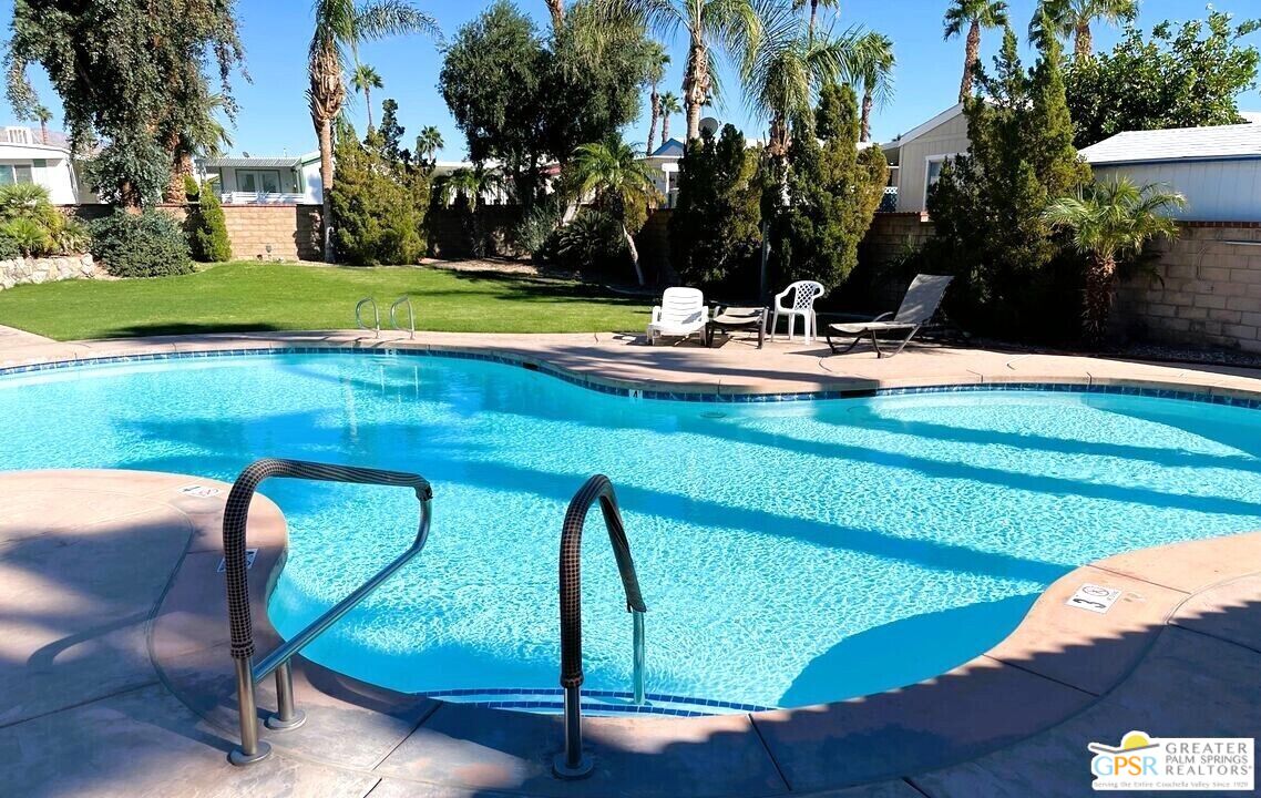 17640 Corkill Road, Unit 37 Desert Hot Springs, CA 92241 - Photo 26 of 35 a view of swimming pool with a table and chairs
