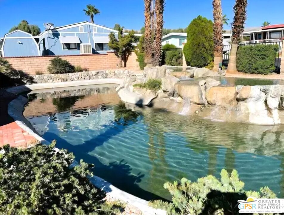 17640 Corkill Road, Unit 37 Desert Hot Springs, CA 92241 - Photo 34 of 35 a view of a lake with a house