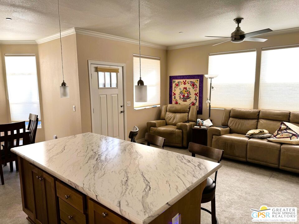17640 Corkill Road, Unit 37 Desert Hot Springs, CA 92241 - Photo 6 of 35 a living room with furniture and a large window