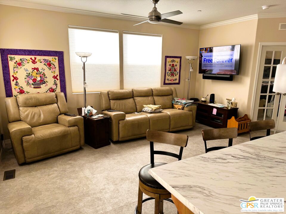 17640 Corkill Road, Unit 37 Desert Hot Springs, CA 92241 - Photo 7 of 35 a living room with furniture a flat screen tv and a large window