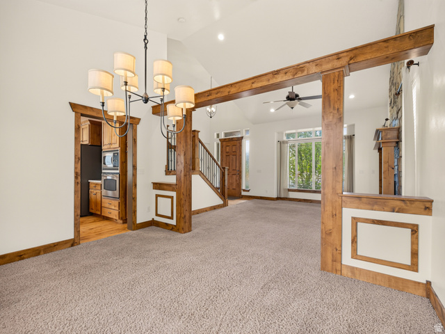 1279 West 1500th Street North Mapleton, UT 84664 - Photo 15 of 83 Spacious open-concept living area featuring a vaulted ceiling and exposed wood beams