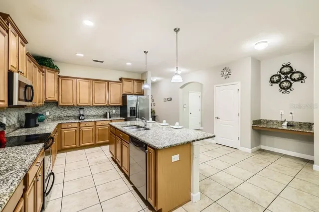 a kitchen with stainless steel appliances granite countertop a sink and cabinets
