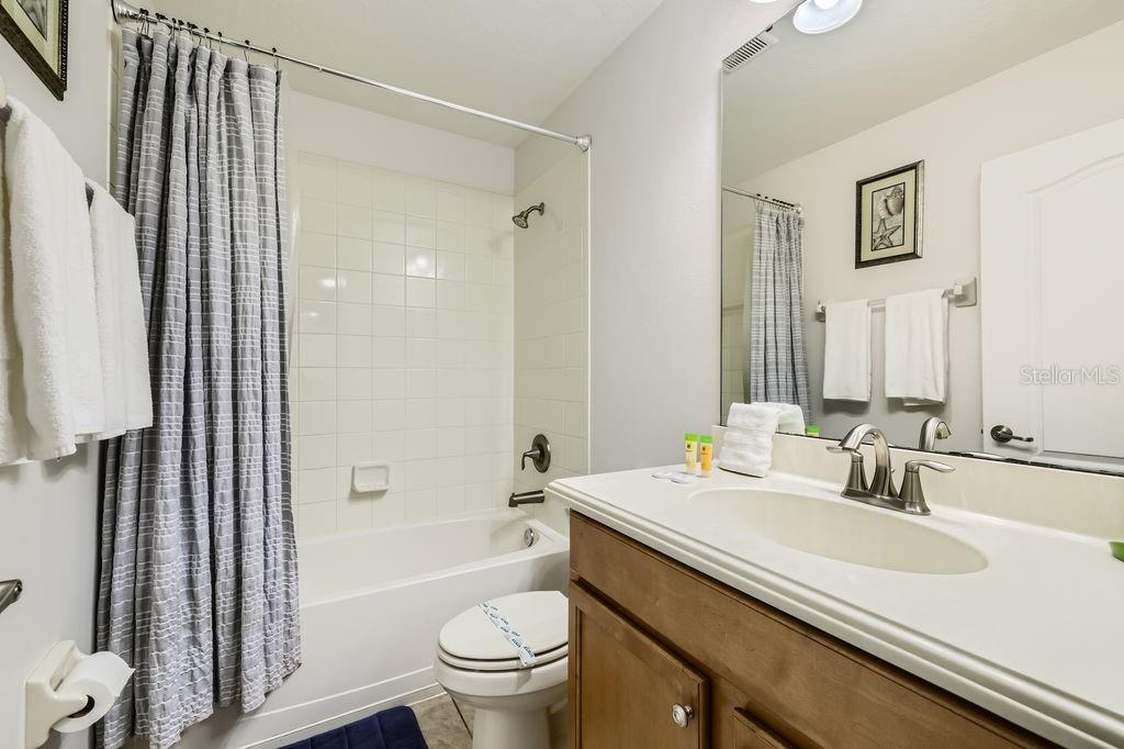 8989 Cuban Palm Road Kissimmee, FL 34747 - Photo 13 of 49 a bathroom with a sink toilet tub and shower