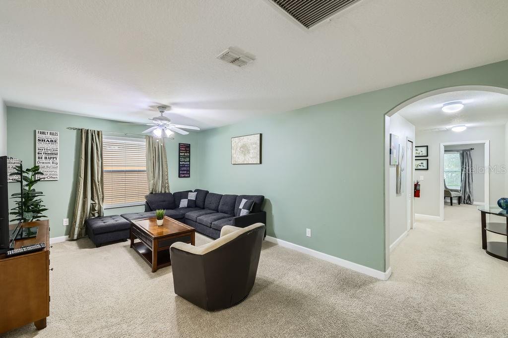 8989 Cuban Palm Road Kissimmee, FL 34747 - Photo 14 of 49 a living room with furniture and a potted plant