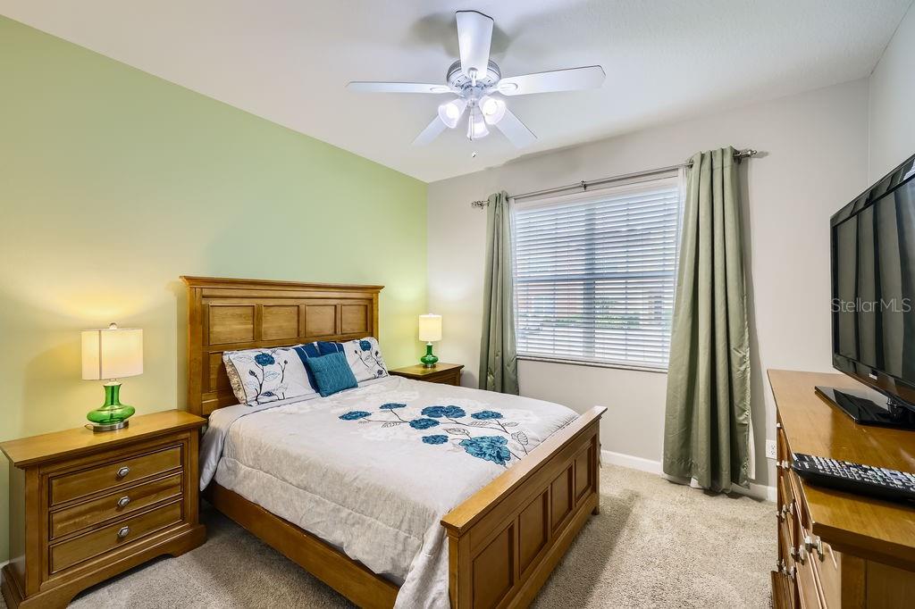 8989 Cuban Palm Road Kissimmee, FL 34747 - Photo 22 of 49 a bedroom with a bed and a flat screen tv