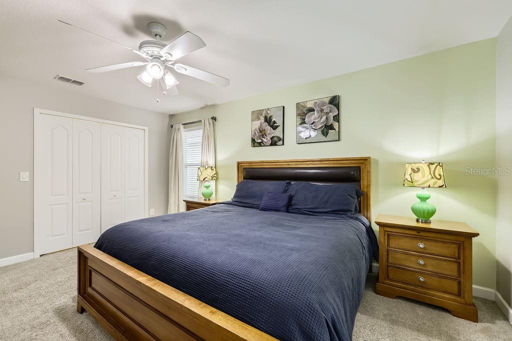 8989 Cuban Palm Road Kissimmee, FL 34747 - Photo 24 of 49 a large bed sitting in a bedroom and night stand