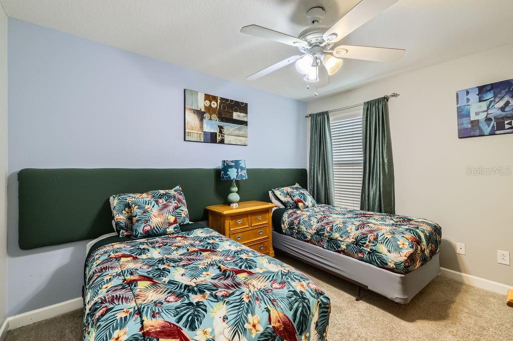8989 Cuban Palm Road Kissimmee, FL 34747 - Photo 26 of 49 a bedroom with bed and window