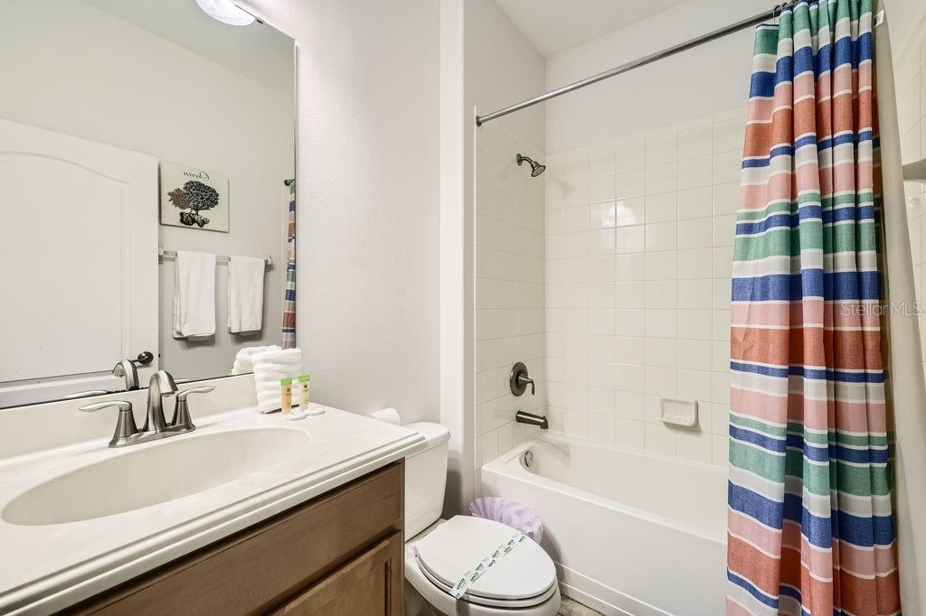 8989 Cuban Palm Road Kissimmee, FL 34747 - Photo 27 of 49 a bathroom with a sink a toilet and shower