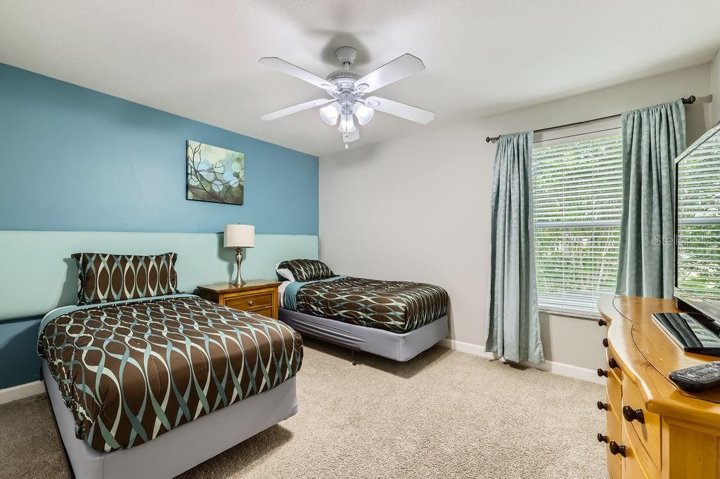 8989 Cuban Palm Road Kissimmee, FL 34747 - Photo 29 of 49 a bedroom with two beds and a window