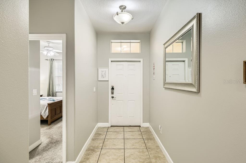 8989 Cuban Palm Road Kissimmee, FL 34747 - Photo 3 of 49 a view of a livingroom with wooden floor and a kitchen space with a sink