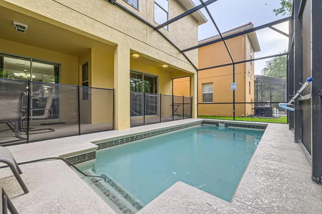 a swimming pool with an outdoor seating and yard