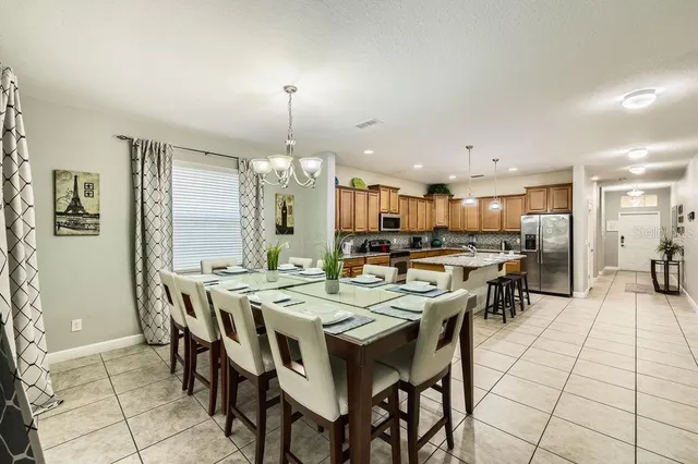 a large kitchen with a table and chairs