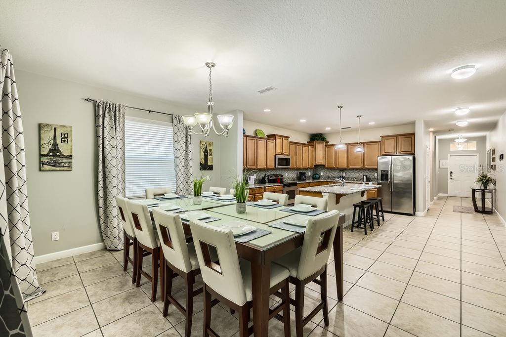 8989 Cuban Palm Road Kissimmee, FL 34747 - Photo 4 of 49 a large kitchen with a table and chairs
