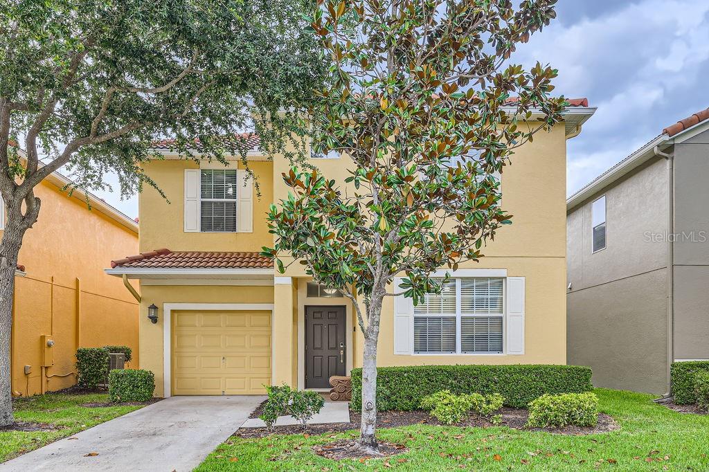 8989 Cuban Palm Road Kissimmee, FL 34747 - Photo 49 of 49 a front view of a house with garden