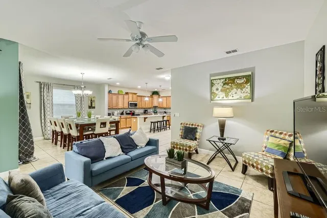 a living room with furniture and a chandelier