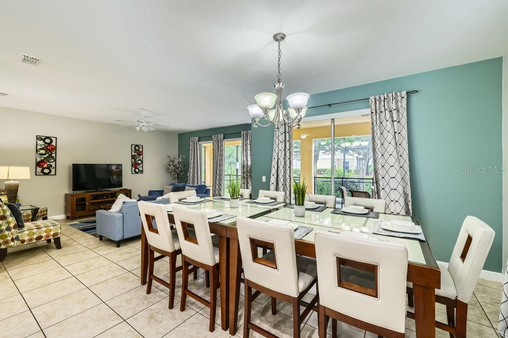 8989 Cuban Palm Road Kissimmee, FL 34747 - Photo 6 of 49 a view of a dining room with furniture wooden floor and chandelier