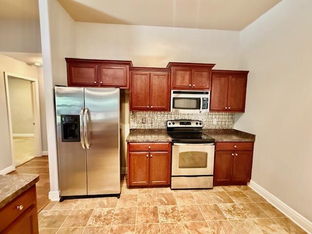 222 Raptor Drive Crestview, FL 32536 - Photo 15 of 42 a kitchen with stainless steel appliances granite countertop a refrigerator stove and microwave