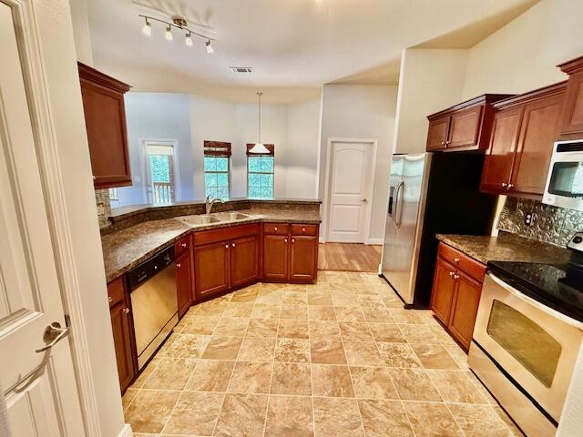 222 Raptor Drive Crestview, FL 32536 - Photo 16 of 42 a kitchen with granite countertop a sink stove and refrigerator