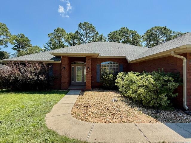 222 Raptor Drive Crestview, FL 32536 - Photo 2 of 42 a front view of a house with garden