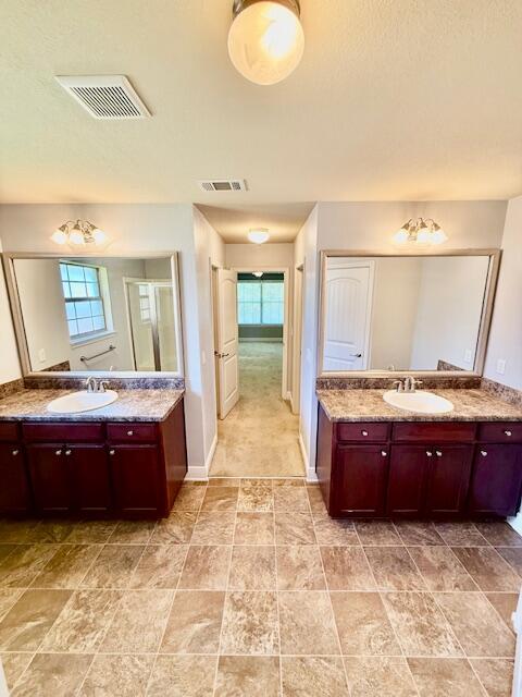222 Raptor Drive Crestview, FL 32536 - Photo 27 of 42 a large bathroom with a tub sink and mirror