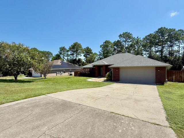 222 Raptor Drive Crestview, FL 32536 - Photo 41 of 42 a front view of a house with a yard and garage