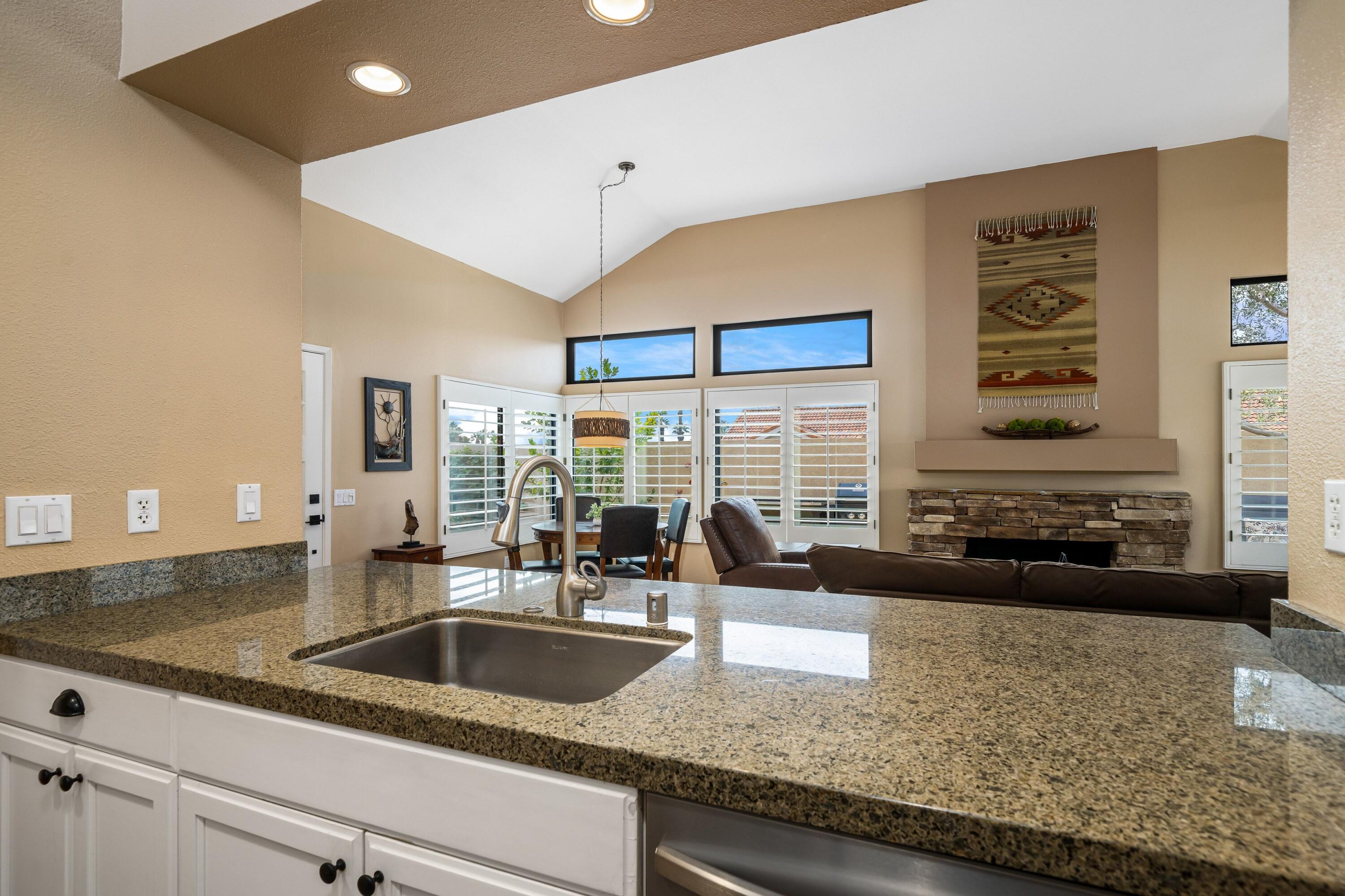 29 Verde Way Palm Desert, CA 92260 - Photo 12 of 43 a kitchen with granite countertop a sink and a counter top space