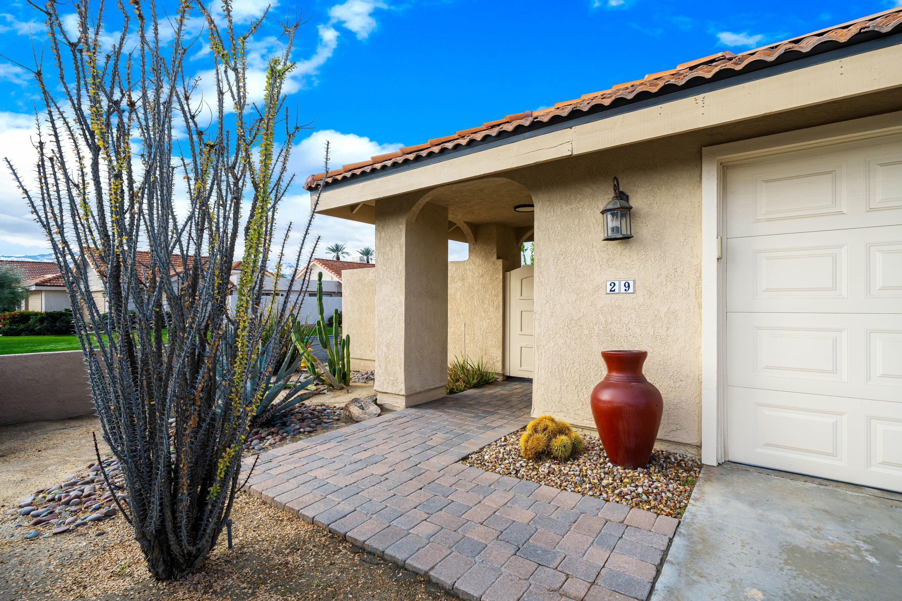 29 Verde Way Palm Desert, CA 92260 - Photo 2 of 43 a front view of a house with garden