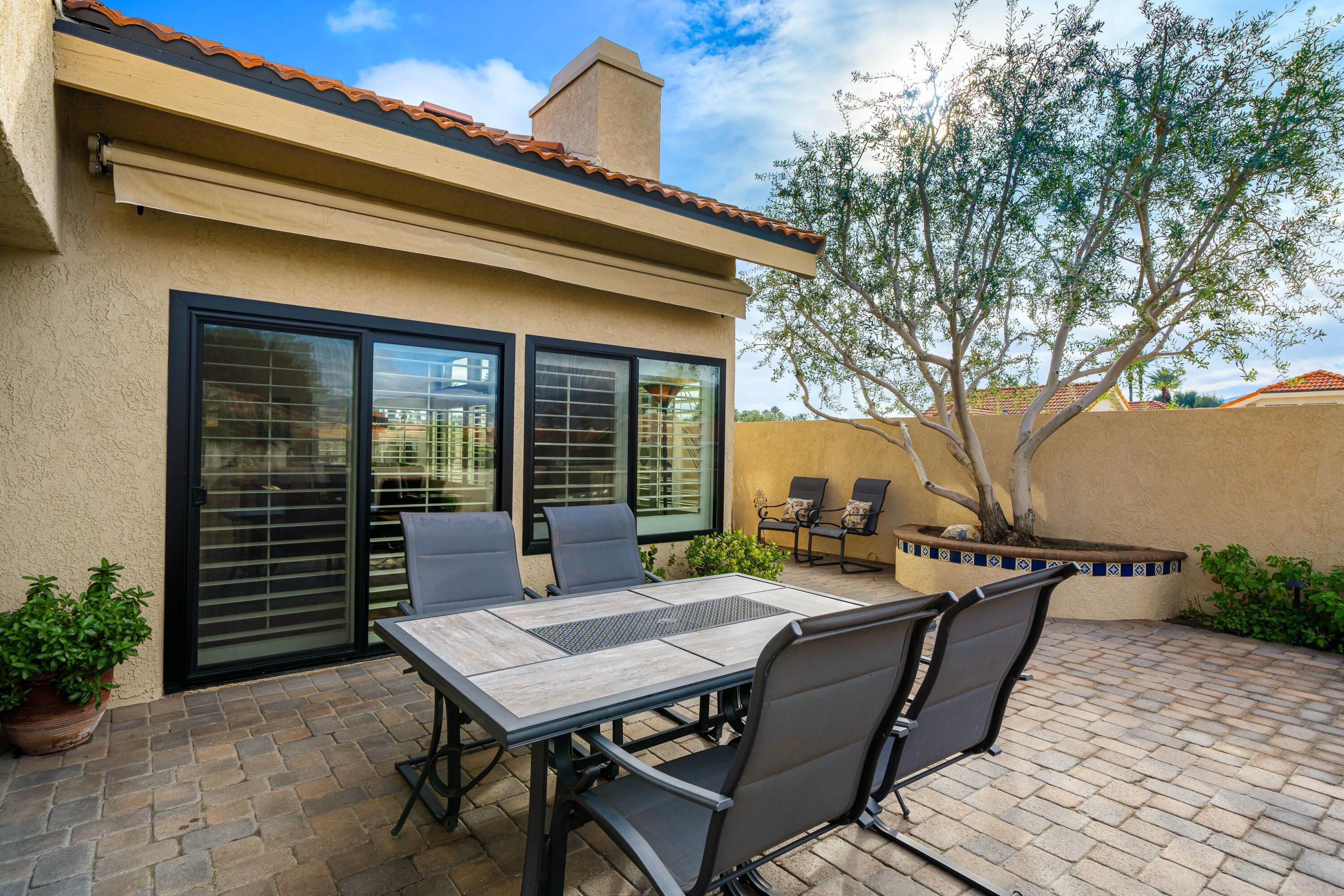 29 Verde Way Palm Desert, CA 92260 - Photo 23 of 43 a view of a patio with table and chairs with wooden floor and plants