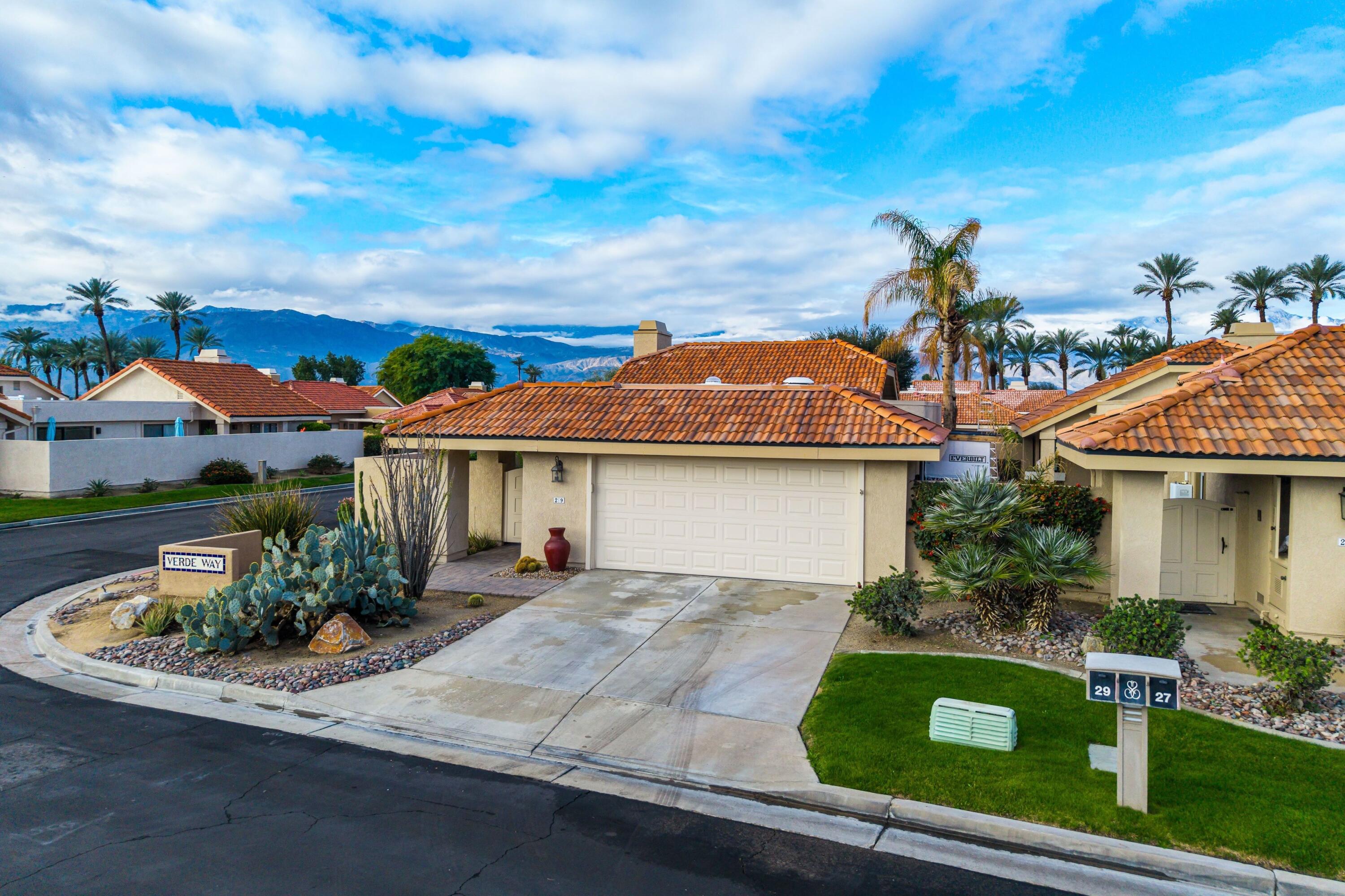 29 Verde Way Palm Desert, CA 92260 - Photo 3 of 43 a front view of house with yard and green space