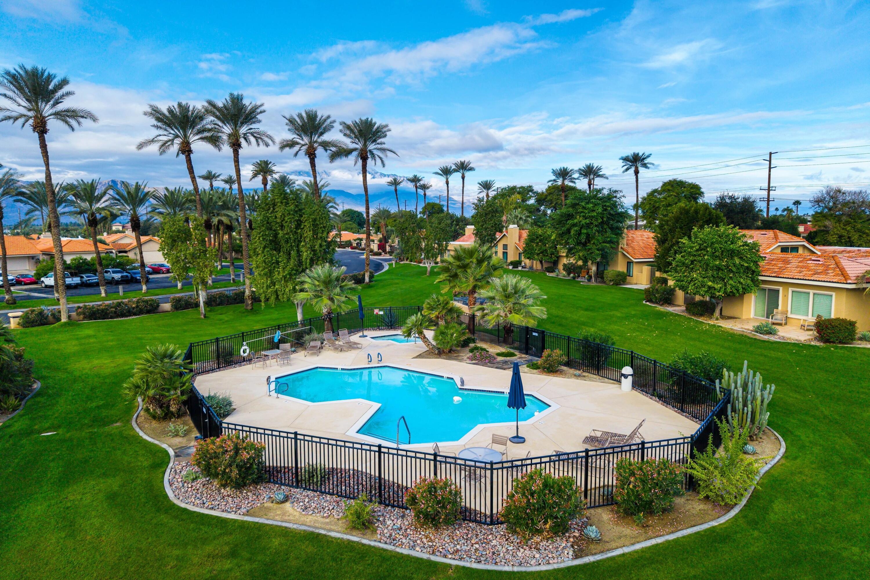 29 Verde Way Palm Desert, CA 92260 - Photo 36 of 43 a swimming pool with outdoor seating and green space