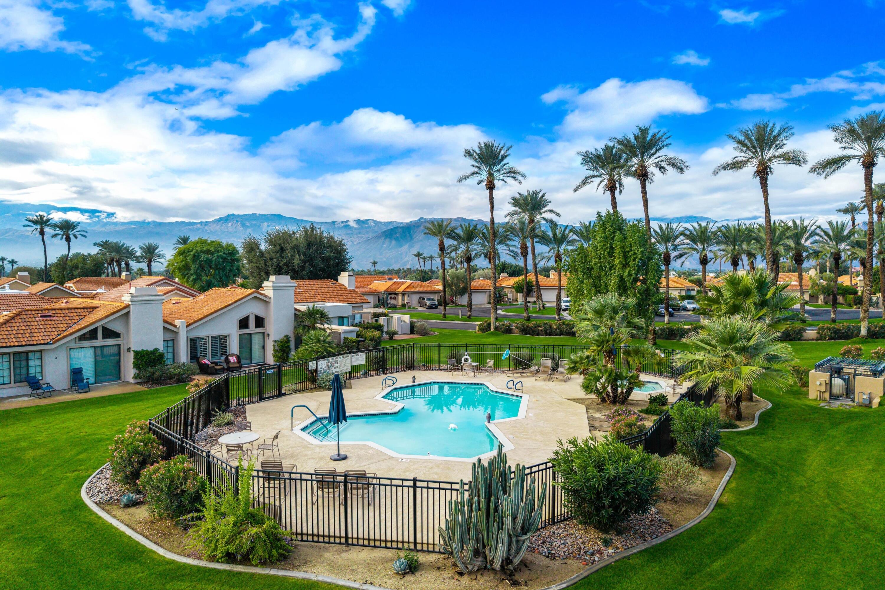 29 Verde Way Palm Desert, CA 92260 - Photo 38 of 43 a swimming pool with outdoor seating and city view