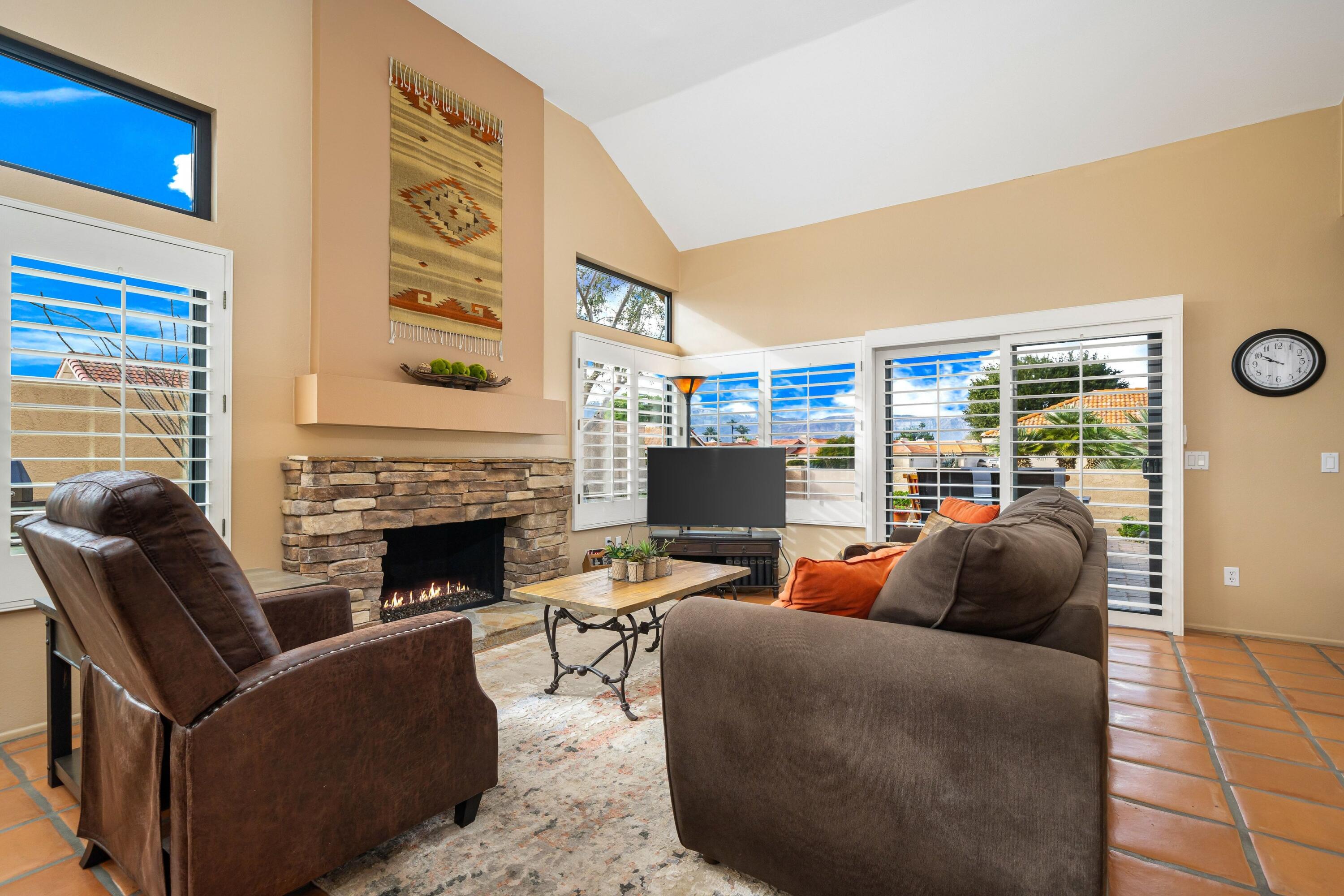 29 Verde Way Palm Desert, CA 92260 - Photo 4 of 43 a living room with furniture and a fireplace